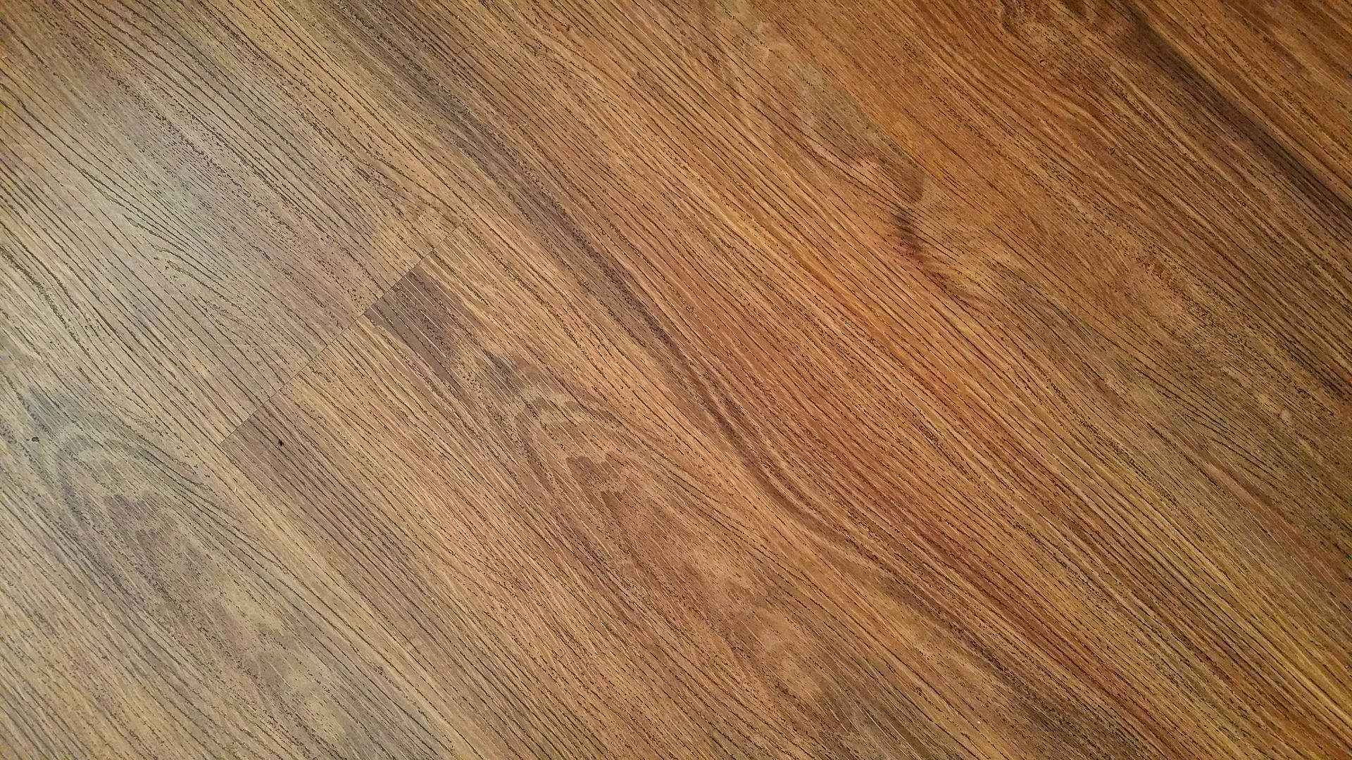 Detailed image of rustic wooden flooring with visible wood grain texture.