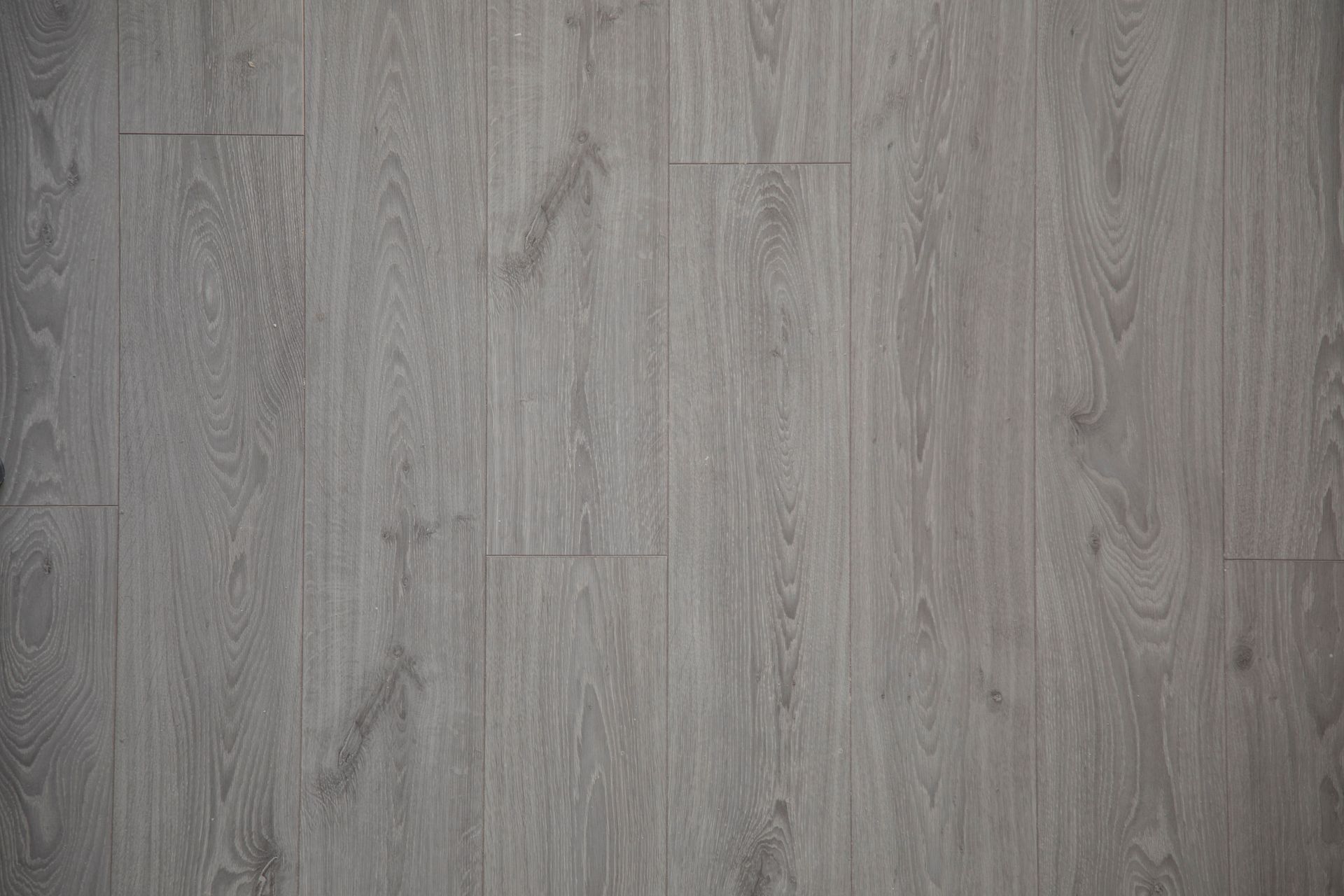 Close-up view of gray wooden floor planks with natural texture and pattern.